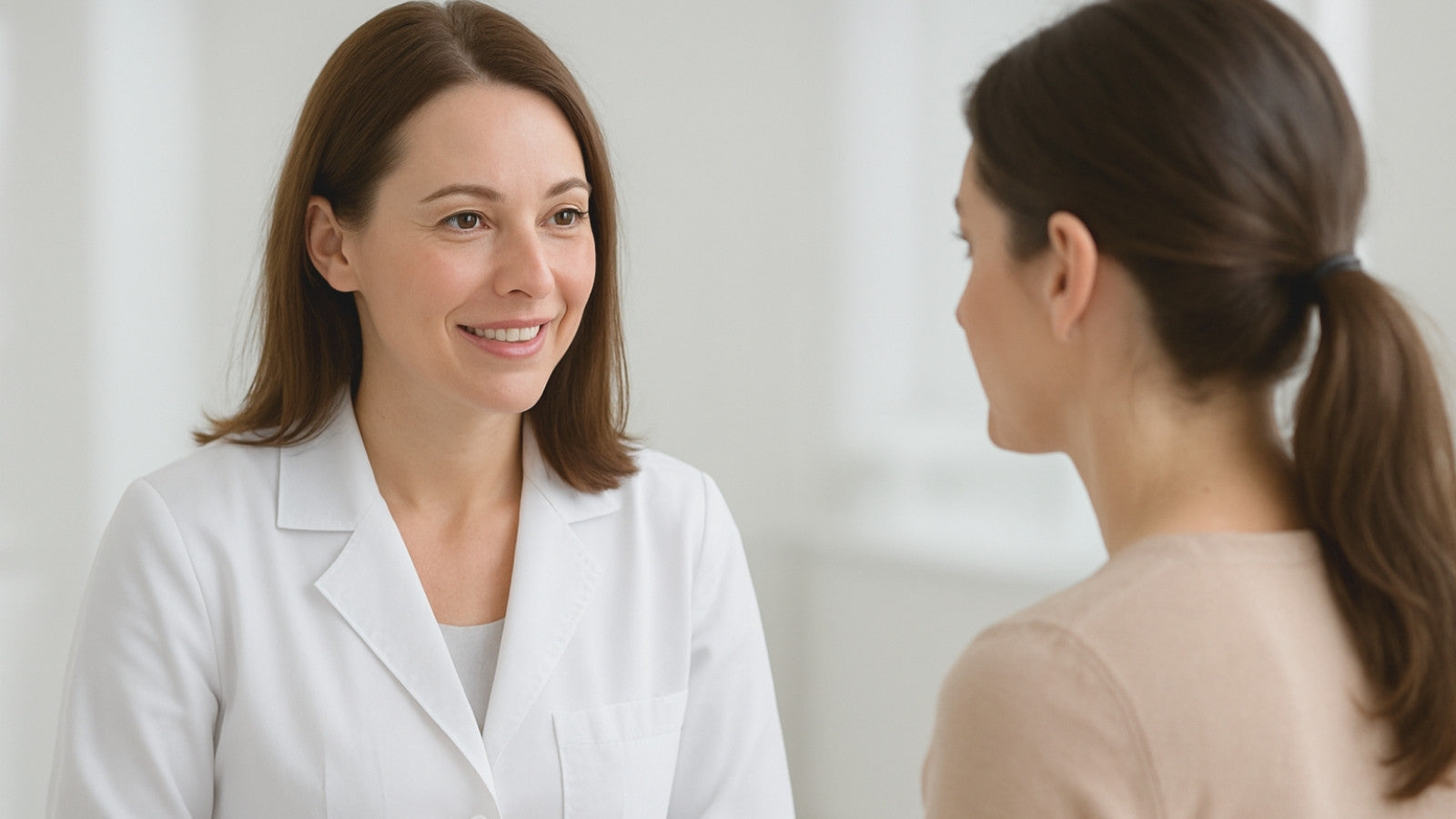 Dermatologist talking with a patient during a consultation in a bright medical office